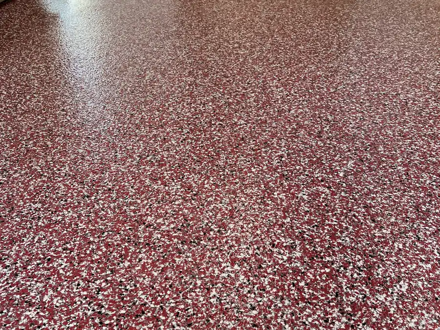 Finished red and white flake epoxy floor coating in a residential garage