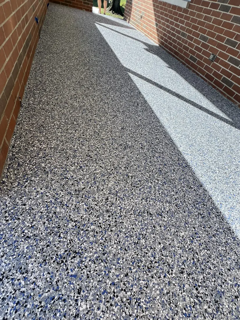 The same concrete walkway finished with a blue, grey and white flake epoxy coating