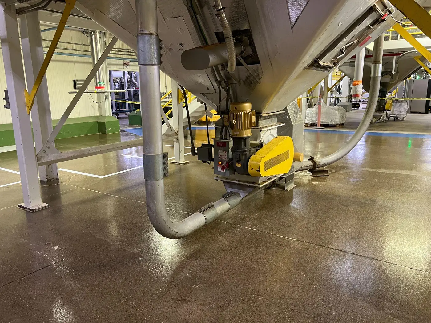 The same plant floor running in under processing equipment and pipework